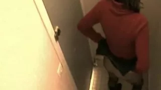 Hot brunette caught in the toilet