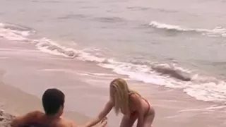 Golden-Haired beauty riding at the beach