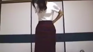 Oriental wife is undressing showing her diminutive breast and large unshaved bush