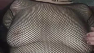 aged wife wearing fishnet squeezes her nipps