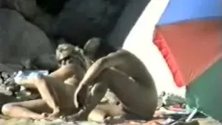 Voyeur spies on older couple having beach joy.avi