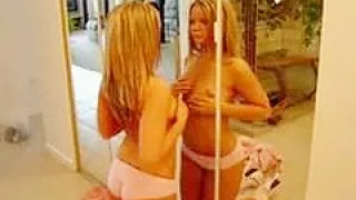 Blonde rubs her tits on the mirror