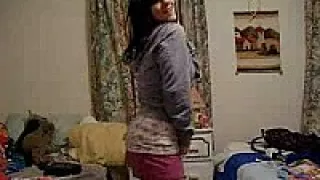 Busty brunette stripping in bedroom