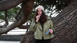 Young Brunette Is Taking An Unhurried Stroll With Allwhite 120mm Cigarette