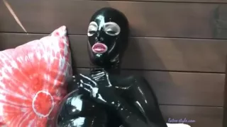 Oil Massage In Black Latex Catsuit