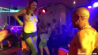 Kinky ladies are teasing a guy who is tied up on the stage, in the night club