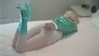 Blonde on bed wrapped in saran wrap