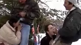 Two crazy girls give head kneeling in the snow on a ski desc