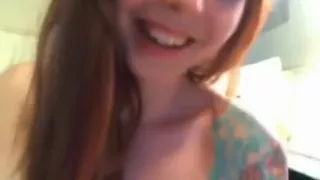 Tattooed redhead dildoing her pussy on cam