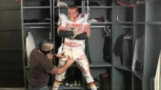 Tall redheaded football player bound gagged and stripped.