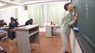 Japanese teacher gives a valuable lesson at the blackboard