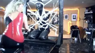 Latex slave tied up in bondage