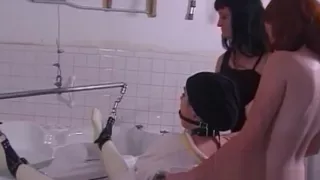 Latex-clad stunner pleasures her ass with a toy before recei