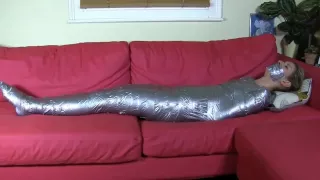 Blonde mummified on sofa