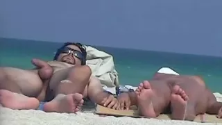 A nude girl is being watched by a beach spy camera