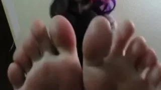 Tattooed Girl Pust Her Feet In Focus And Teases