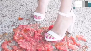 Tomato crushed and destroyed under White heels