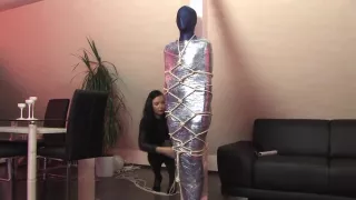 Lycra and shrink wrap mummification, and rope harness