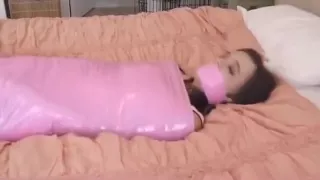 Mummified and gagged with a pink tape