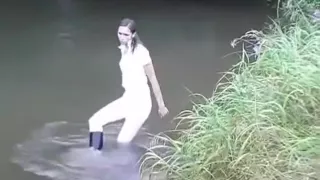 Girl gets wet in creek in riding attire