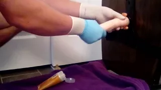 Guy riding dildo in surgical gloves