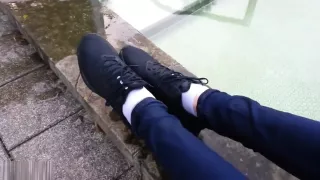 Girl wearing Nike sneakers enters mini-pool