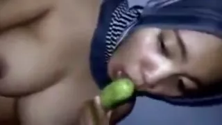 Muslim girl uses a veggie dildo and fingers her pussy