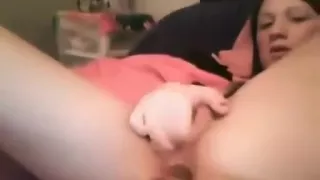 Brunette teen masturbates with a vibrator on her bed