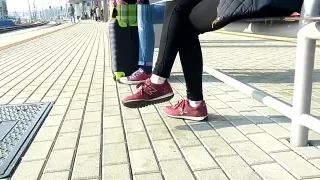 Candid girl wearing new balance sneakers waiting for a tain