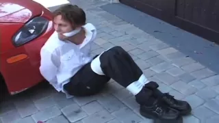 Blake tied up and cleave gagged in parking garage.