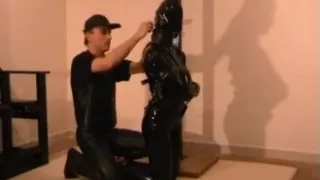 Heavy rubber straitjacket bondage