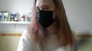 Girl painting her hair in surgical mask and gloves