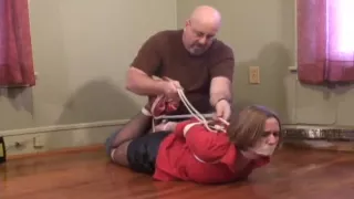 Girl with red blouse hogtied and gagged