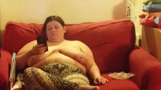 wife chilling on her phone top less smoking