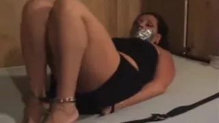 Hogcuffed girl on bed