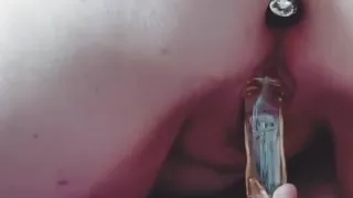 Chubby wearing butt plug fucks herself with glass dildo