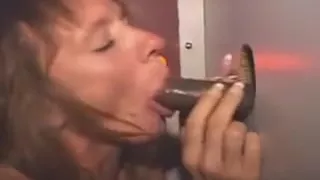 Redheaded Milf Sucking Black Dick Through A Glory Hole