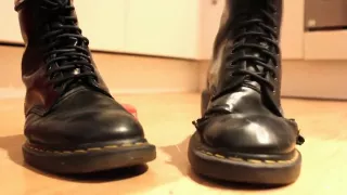 Girl wiggles her toes in soft, well worn Doc Martens and crushes a toy car