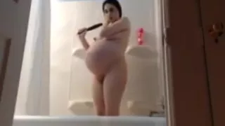 pregnant latina huge belly in te bathroom