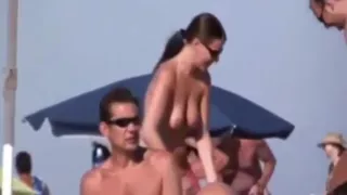 a couple masturbates on nudist beach