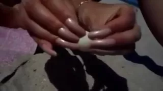 Long nails and sand on the beach