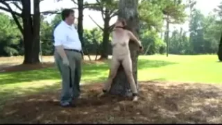 Woman tied to tree for light bondage