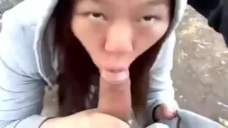 Cute asian girlfriend blowjob in the park