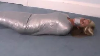 Girl wrapped in duct tape like a mummy