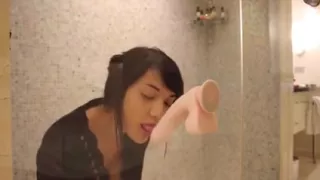 Hot asian uses a dildo in the shower