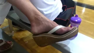 Lady with nice feet dangling flip flops