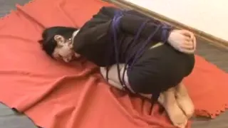 Fetish porn with tied brunette lying on the floor