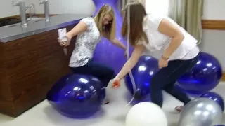 Two amateur girls Pop balloons