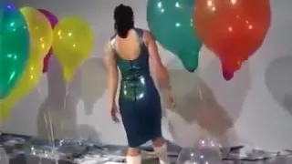 Sexy Girl In Latex Dress Blows to Pop Some Big Balloons