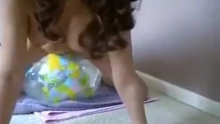 naked girl riding transparent earth beachball